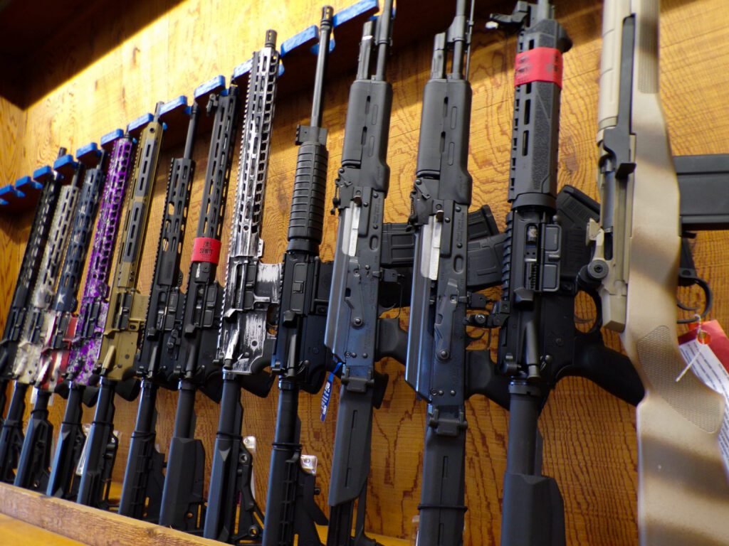A wall-mounted display of various rifles